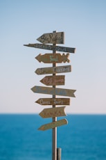 brown wooden road sign during daytime