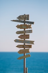 brown wooden road sign during daytime