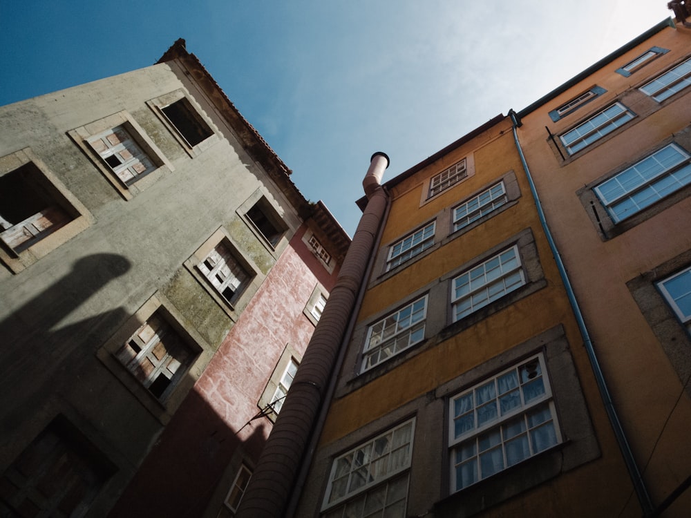 low angle photography of two buildings under clear sky