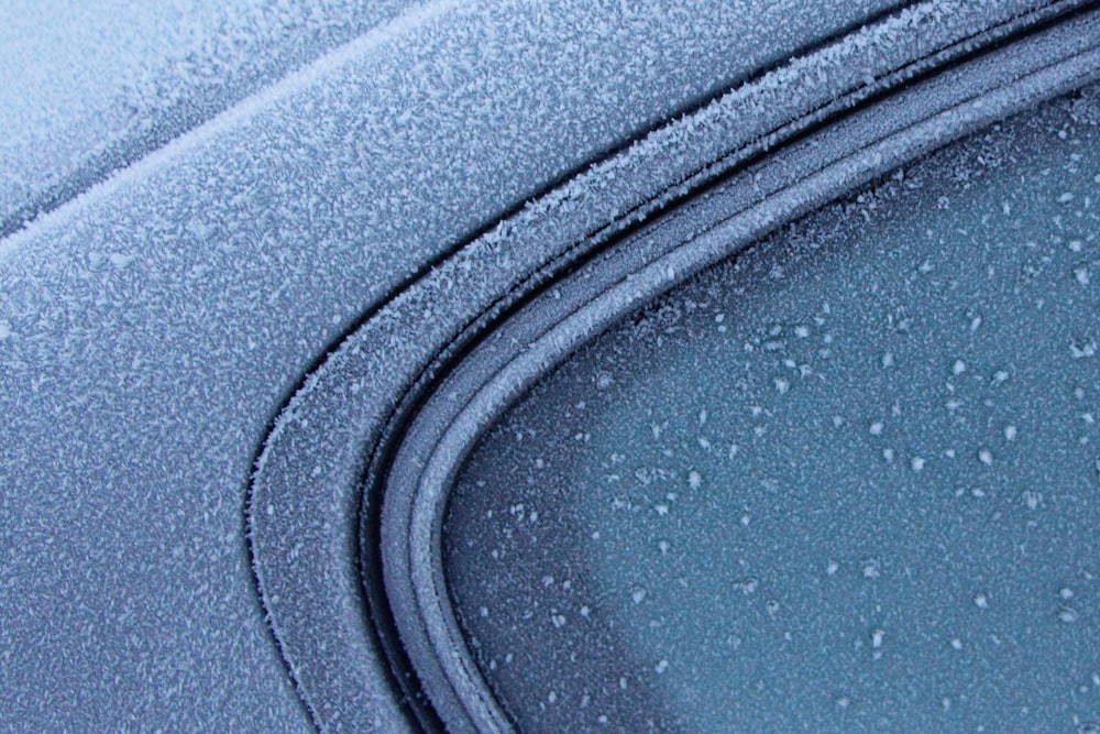 a close up of a car's windshield with drops of water on it