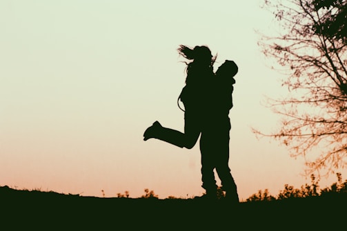 a silhouette of a man and a woman holding each other