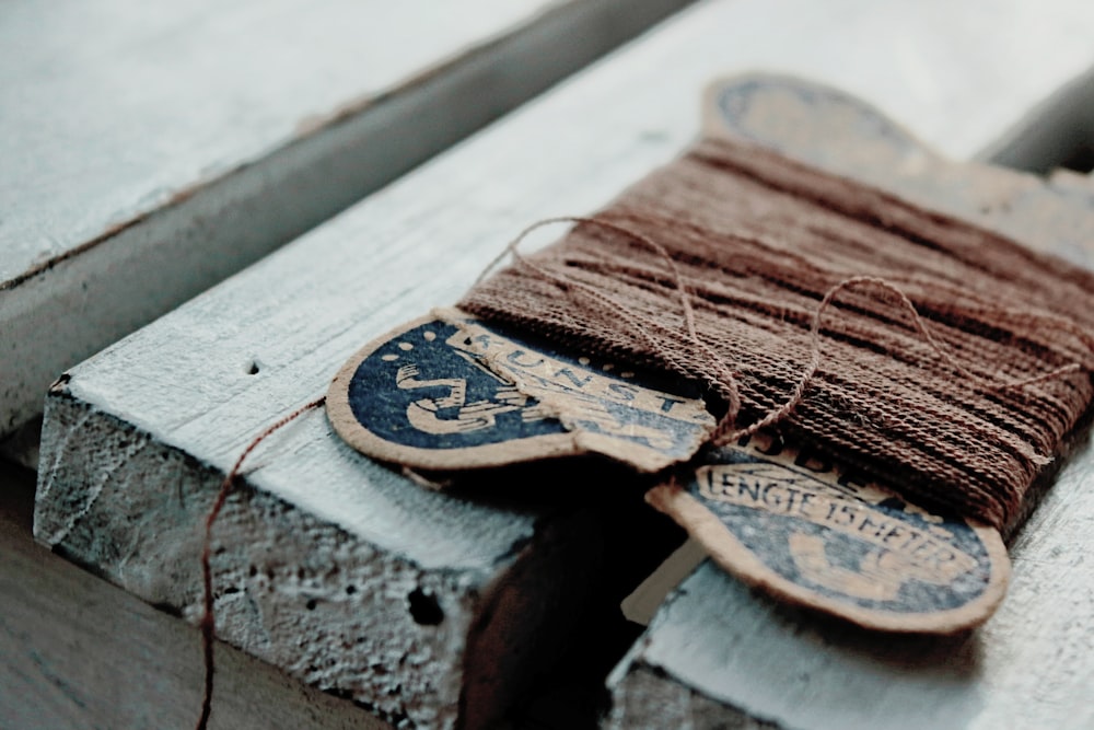 brown sewing thread on white surface