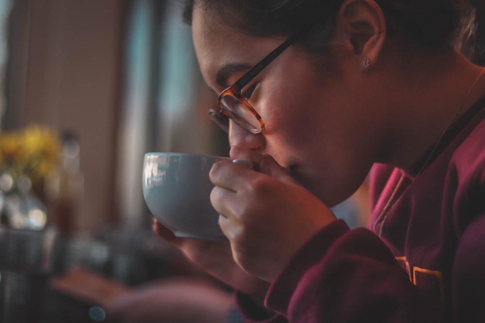 woman holding ceramic mug