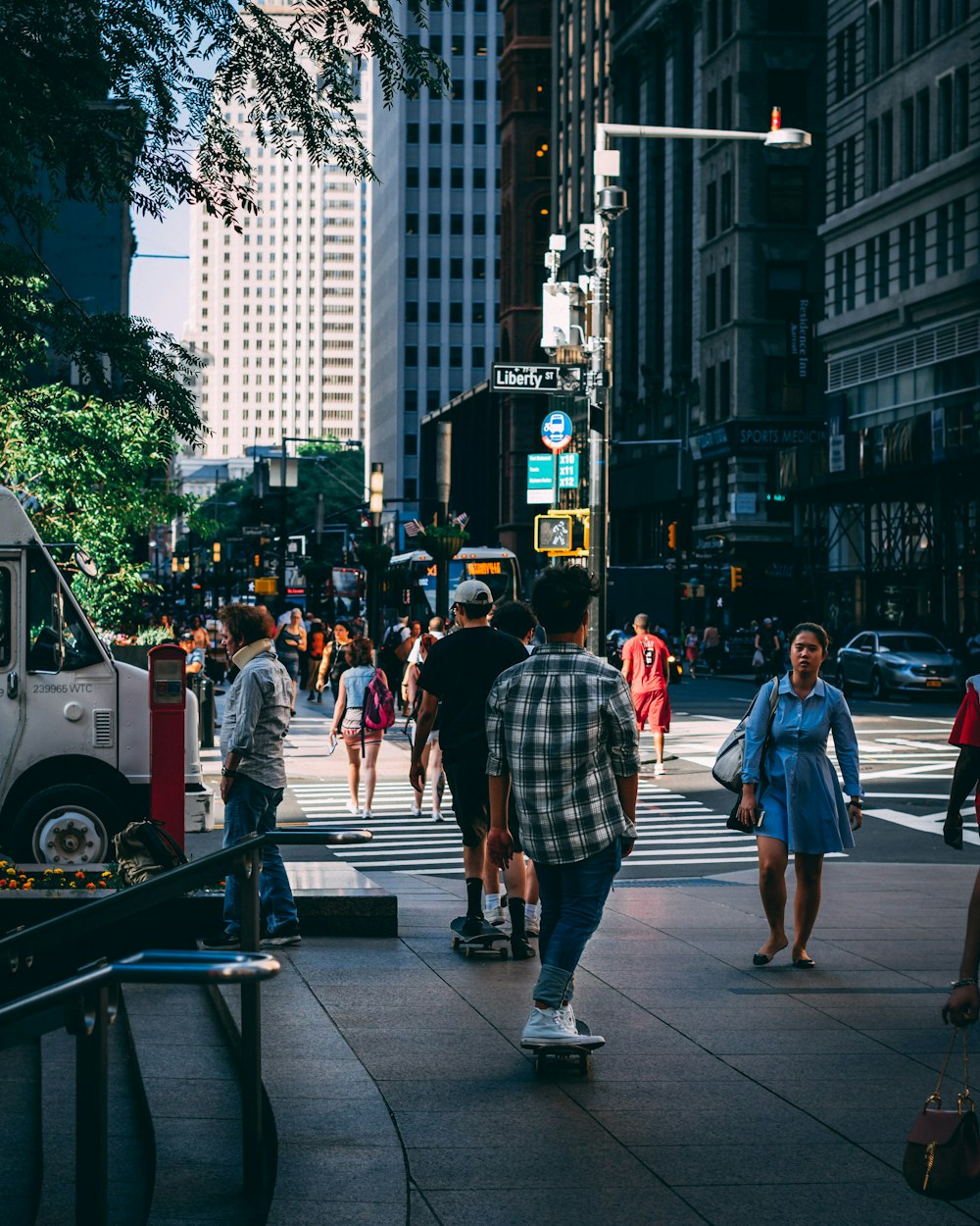 lowlight photography of man riding skateboard on street