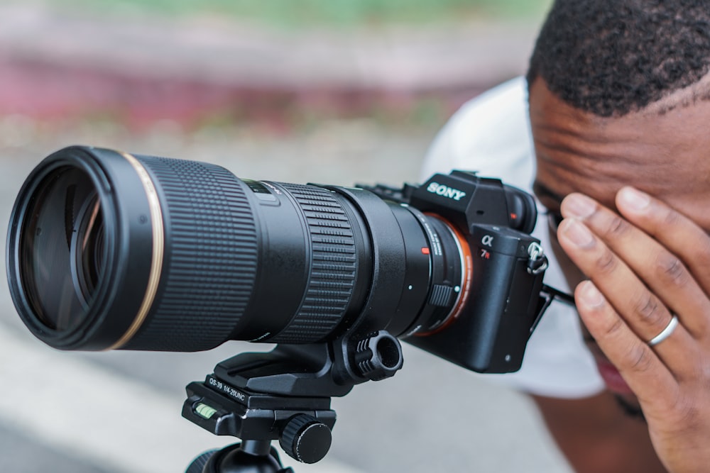 man looking on DSLR camera