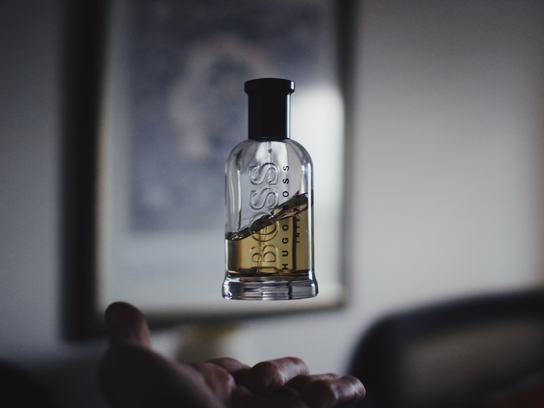 shallow focus photography of floating perfume bottle