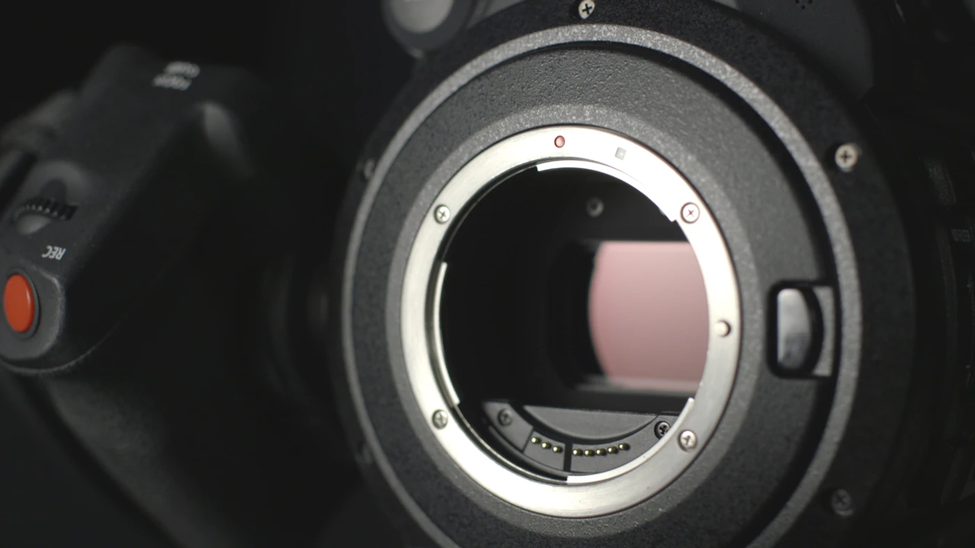 Close-up of a camera body with no lens fitted, the sensor visible inside the metal lens mount