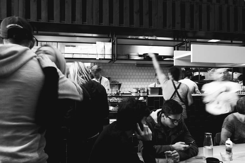 grayscale photo of people inside building