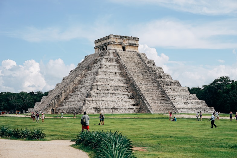 group of people standing ear gray Mayan temple