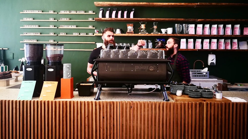 two men standing near counter in coffee shop