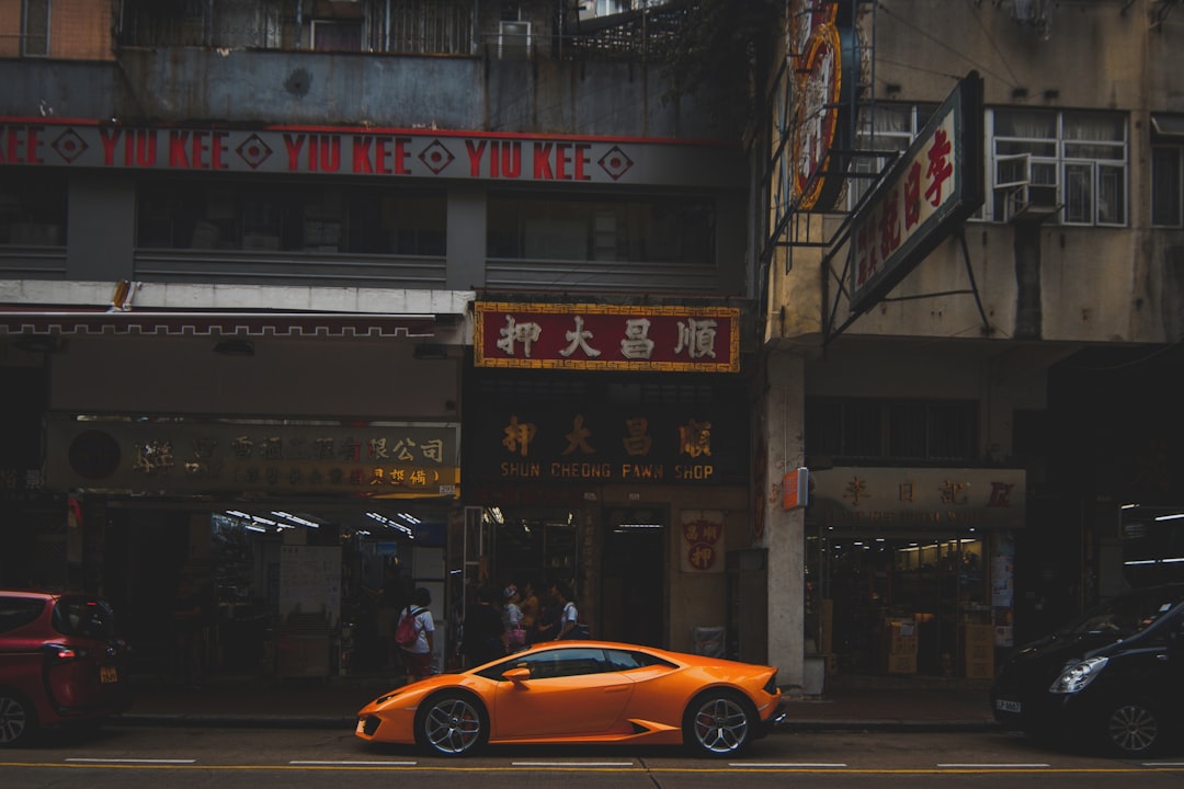 orange Lamborghini Aventador parked infront of restaurant