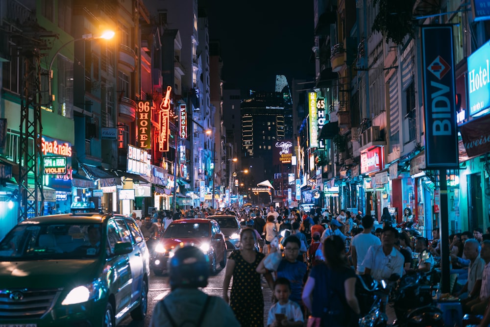 group of people walking on street during nighttime