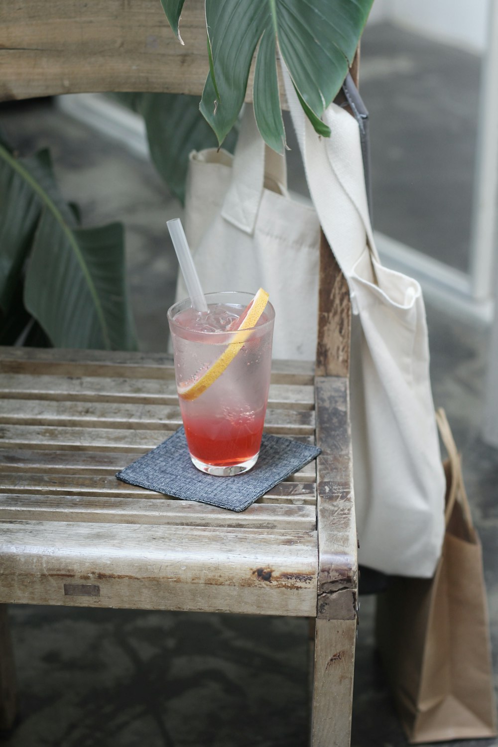 clear glass cup filled with liquid on wooden bench