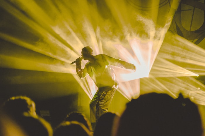 Musician performing live under dramatic stage lights