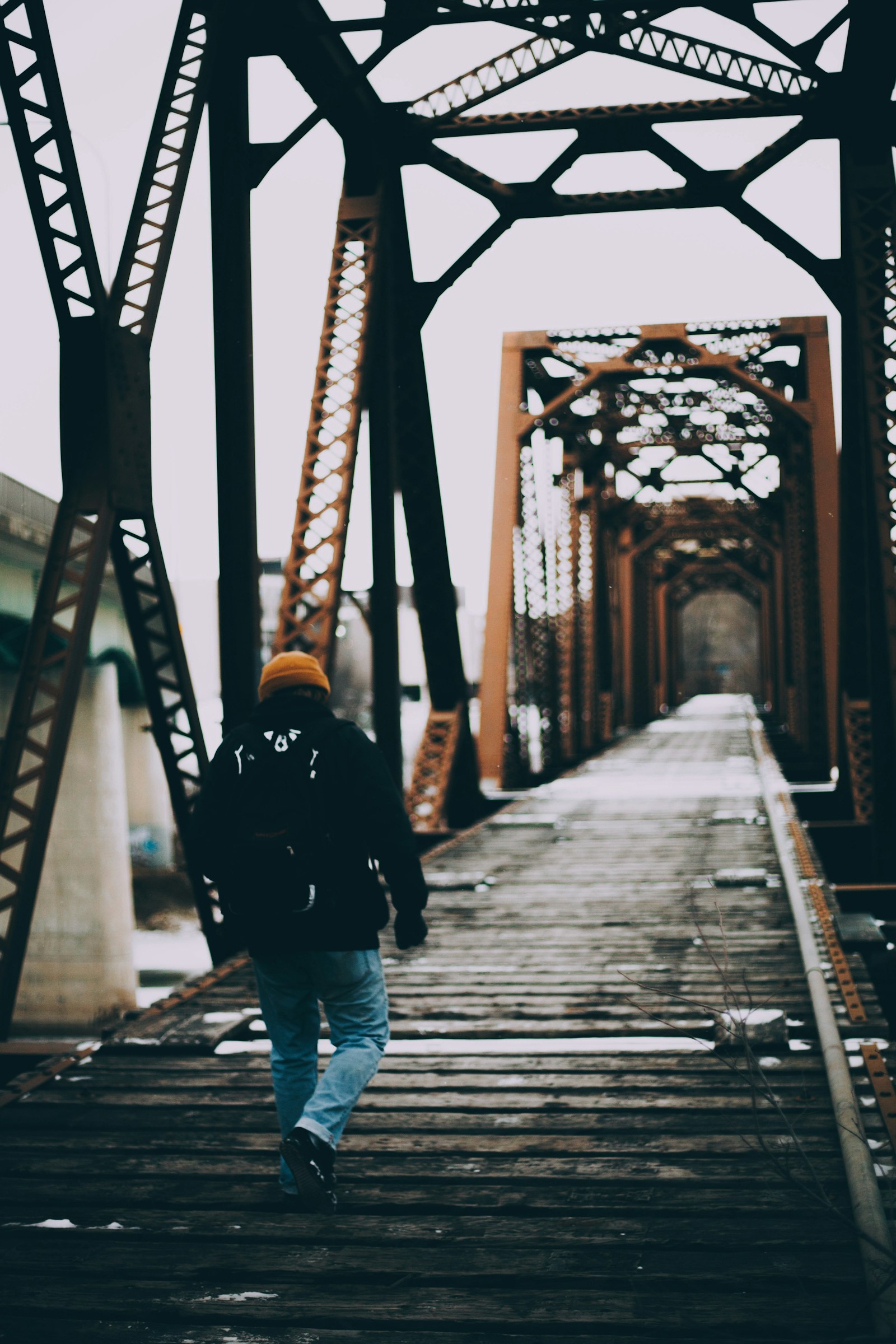 a person walking down a railway bridge