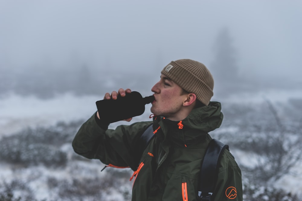 man drinking on flask