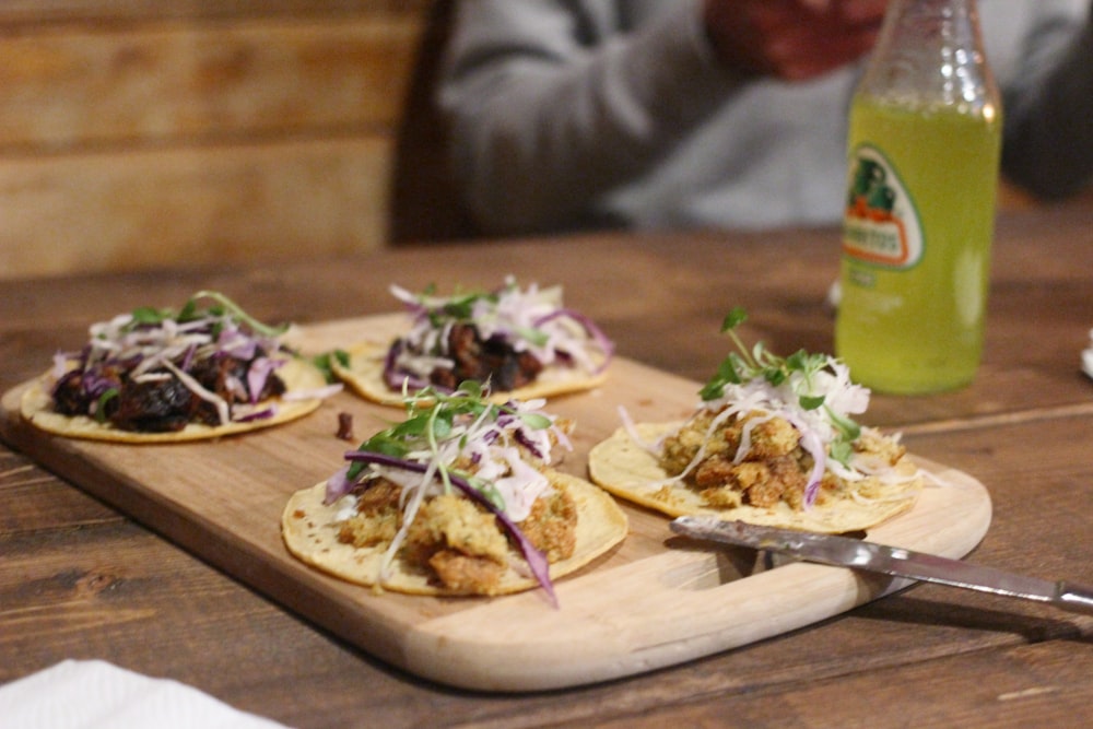 board of four soft tacos on table