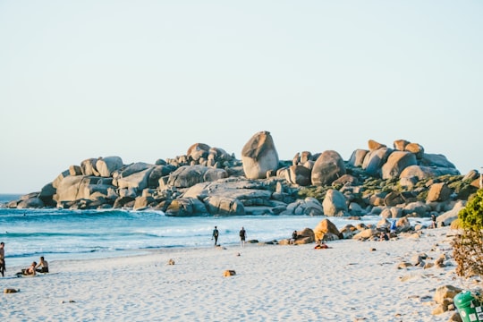 people walking on sand near beach in Llandudno South Africa