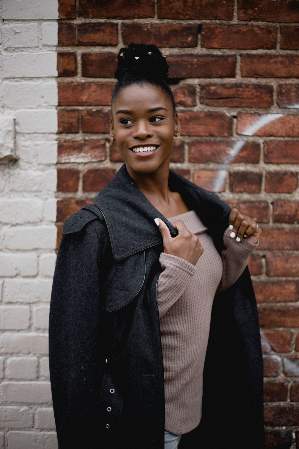 woman in brown tube top under black jacket