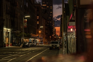 An urban street scene captured at dusk, highlighting the textures and stories of the neighborhood