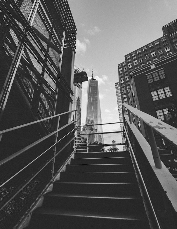 grayscale photography of stairway leading to building