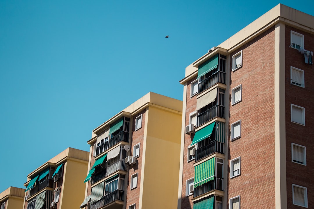 brown apartments under clear blue sky during daytime