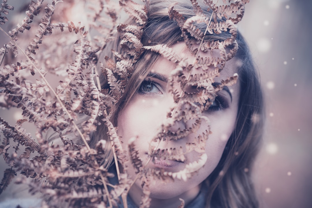 woman behind brown plant