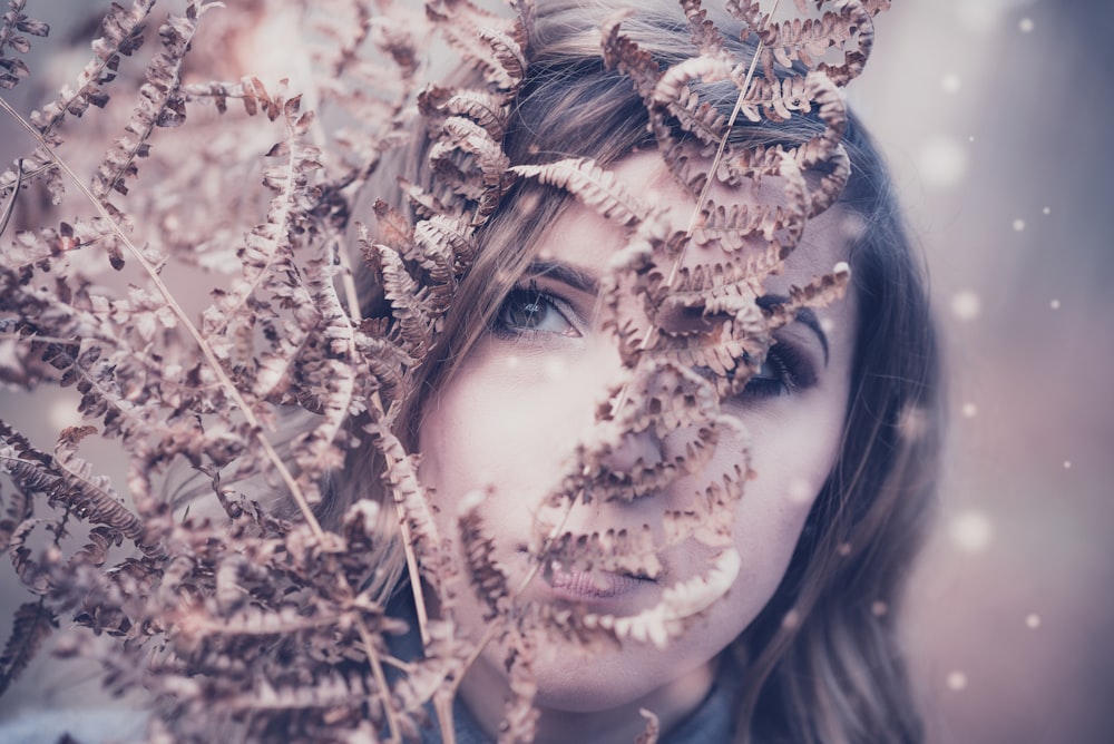 woman behind brown plant