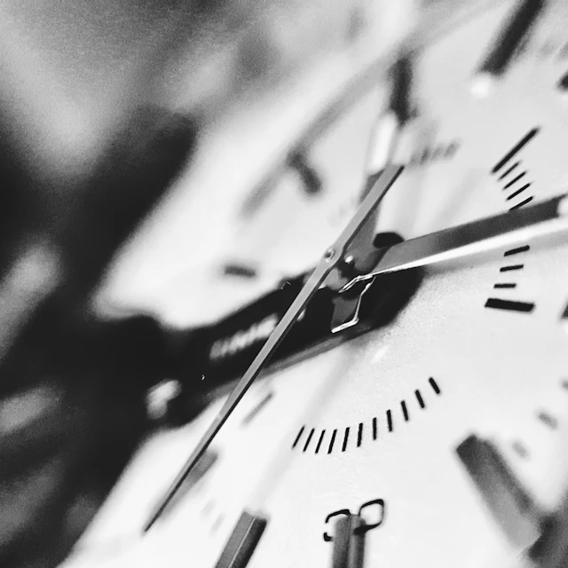 A black and white photograph of a clock face