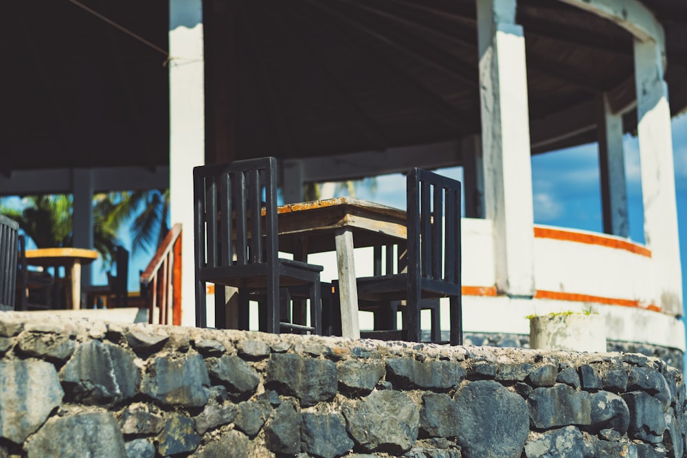 brown wooden table with two chairs set