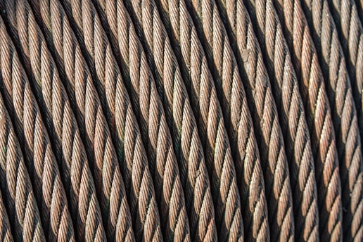 A close-up of high-performance para-aramid fibers in various colors, showcasing their strength and flexibility.