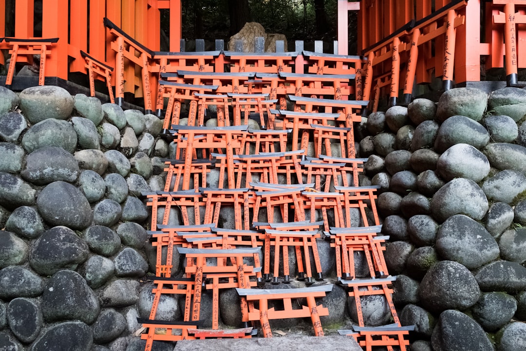 brown wooden stools near pile of gray rocks