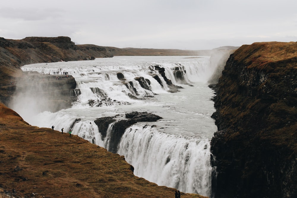 waterfalls under white skies