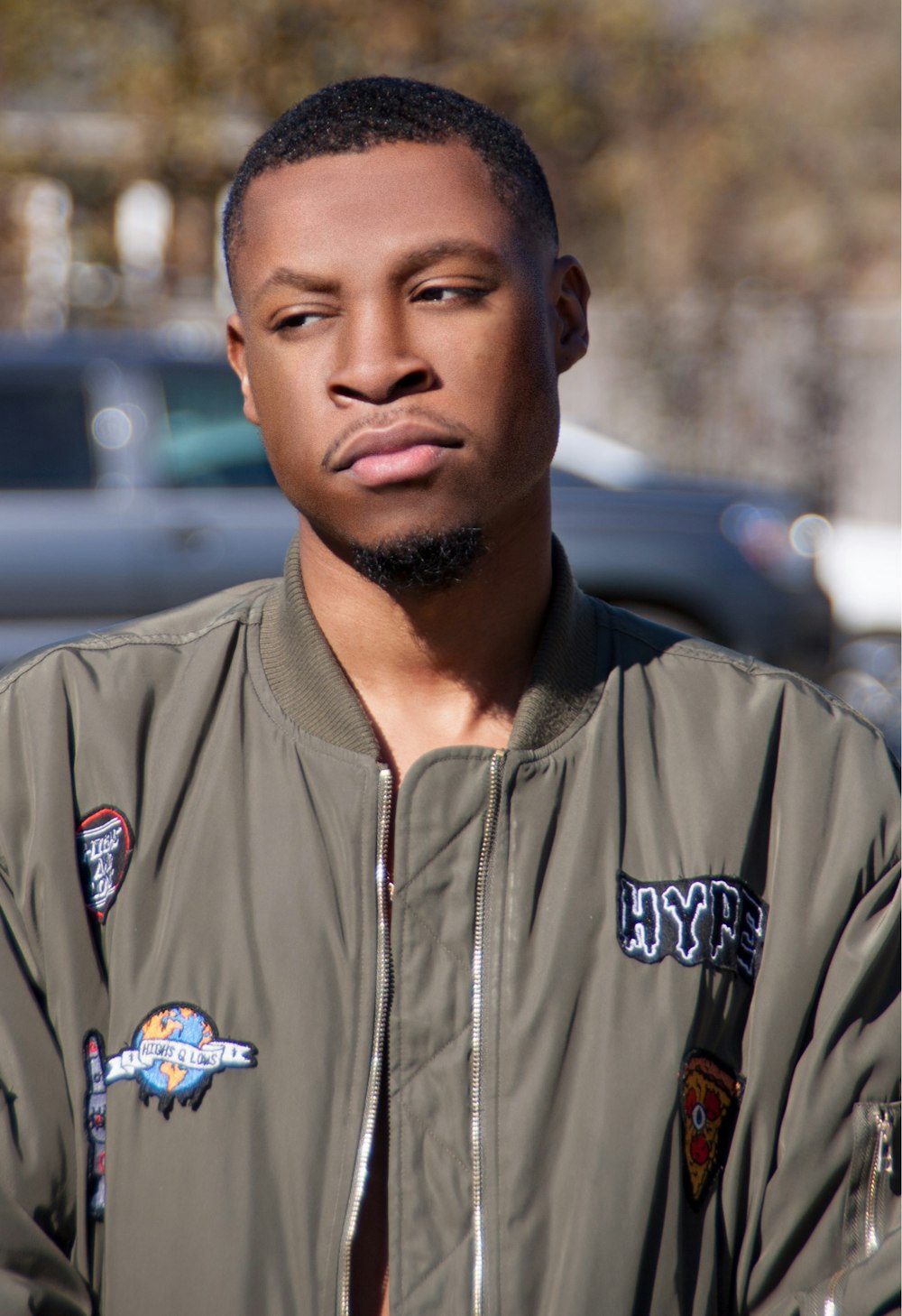 man wearing gray bomber jacket