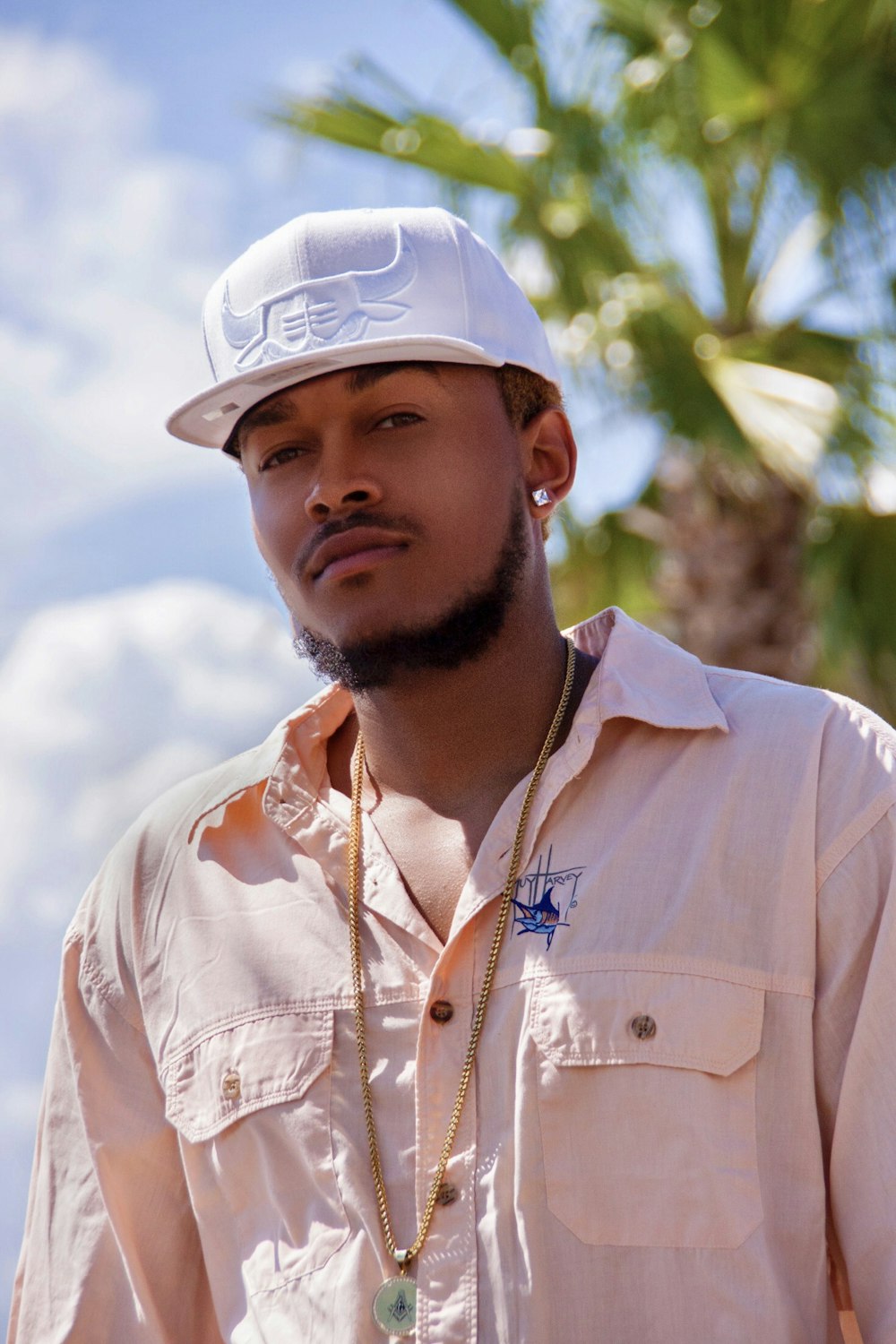 man wearing white fitted hat posing