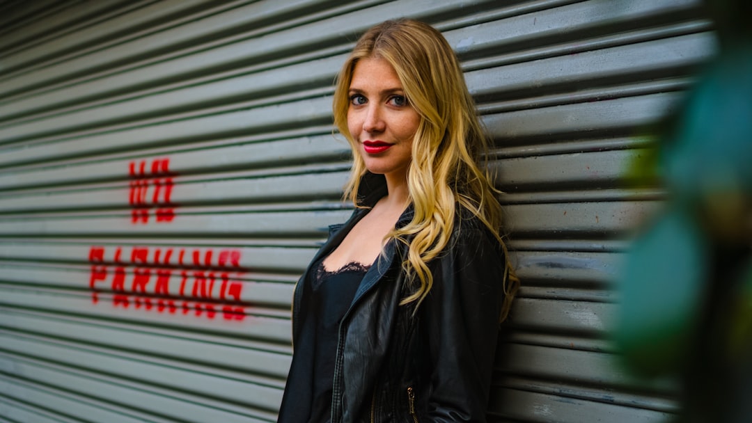 woman standing in front of grey shutter door