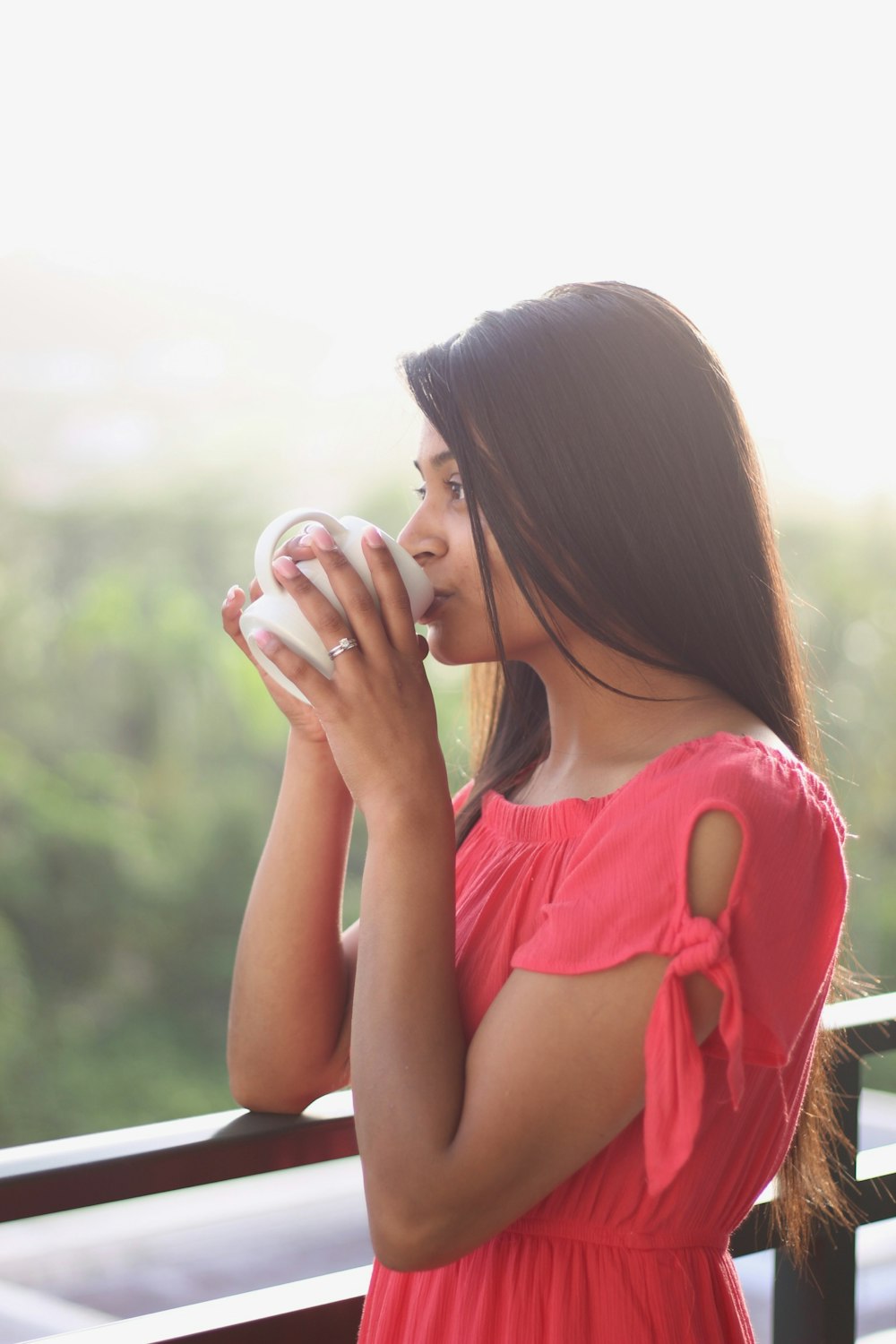 woman drinking on white ceramic mug