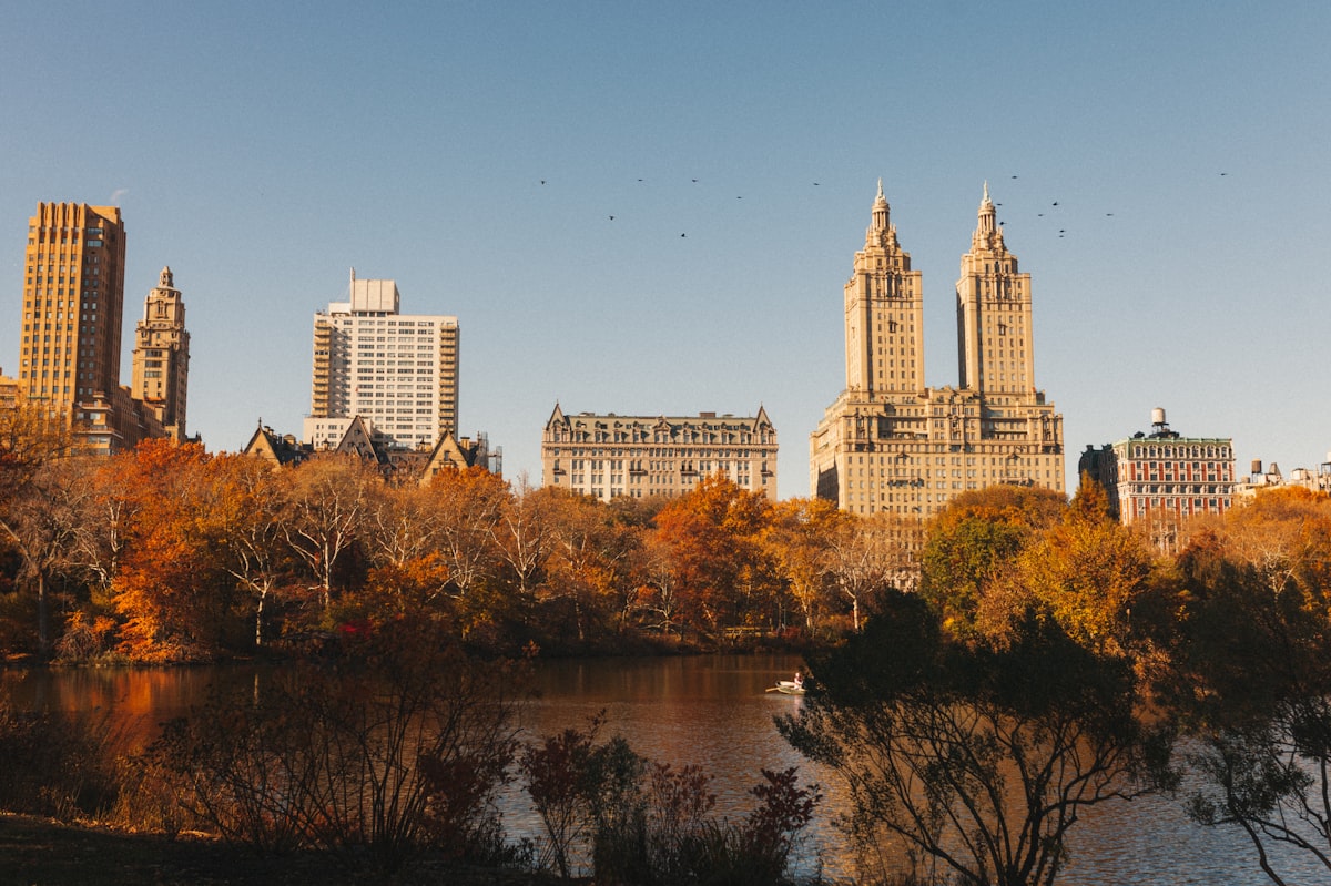 The San Remo towers above the Central Park lake in autumn gold