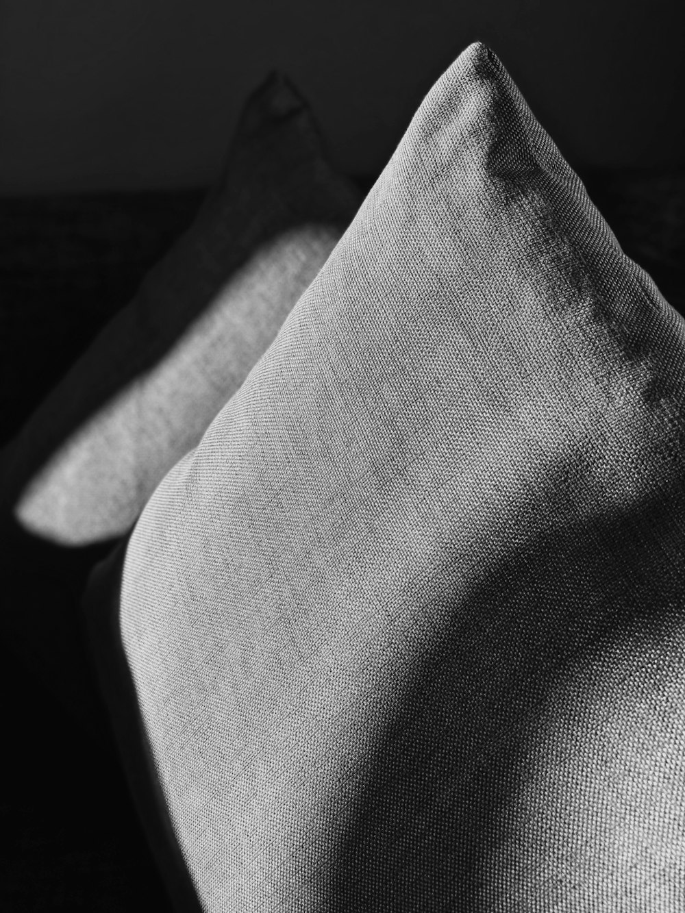 two grey throw pillows closeup photography