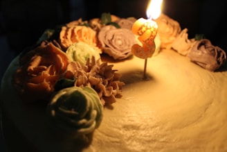 A beautifully decorated multi-layered birthday cake with colorful frosting and fresh flowers