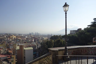 Wide shot of musæ's rooftop lounge with the San Salvador volcano framed perfectly at sunset.
