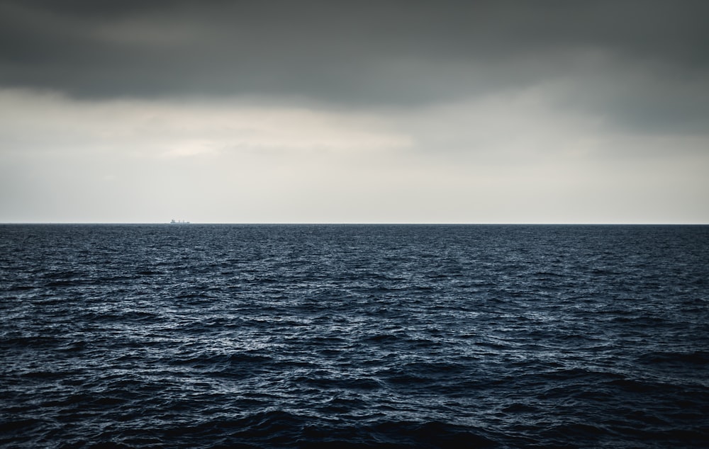 a large body of water under a cloudy sky