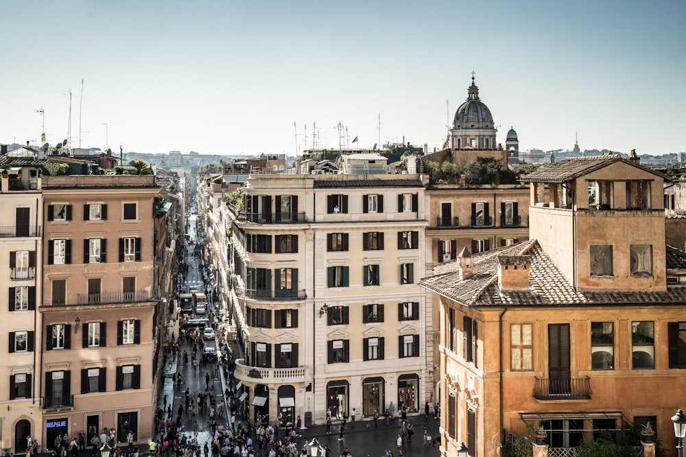 top view photography of divided buildings beside road near cathedral under white and blue skies