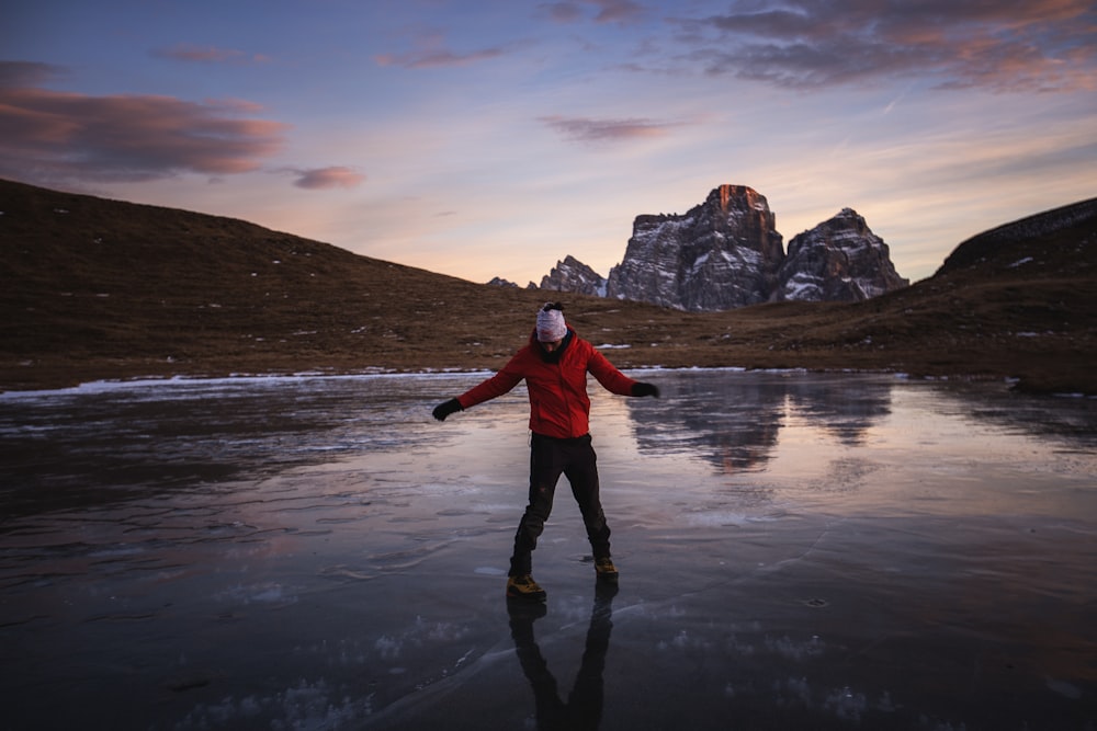 person standing on frozen body of water