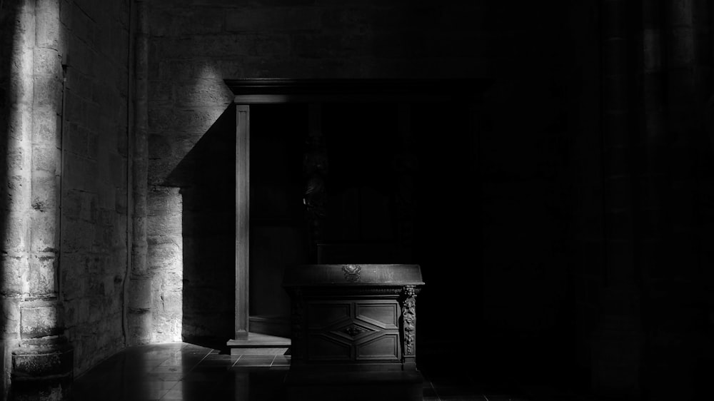 a black and white photo of a dark room