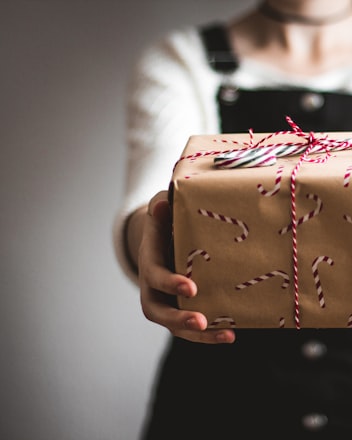 person showing brown gift box