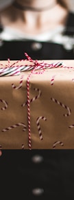 person showing brown gift box