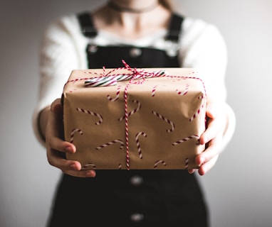 person showing brown gift box