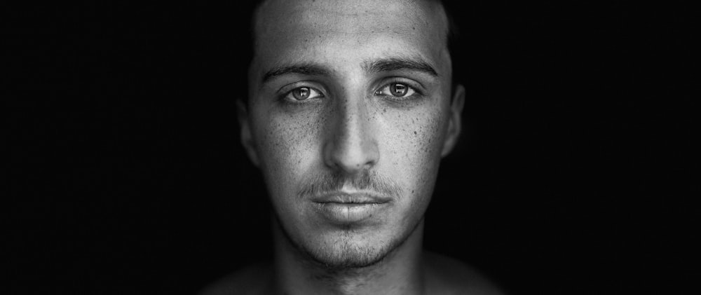 grayscale photo of mans face