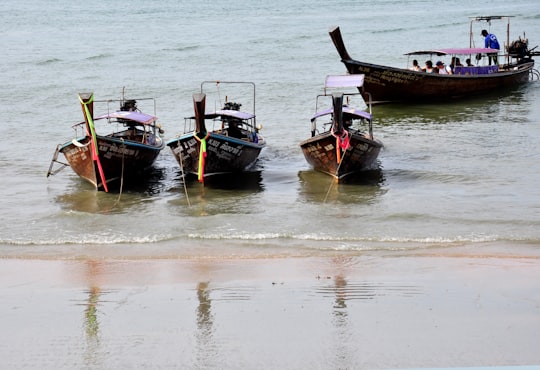 four canoes on beach in Krabi Thailand